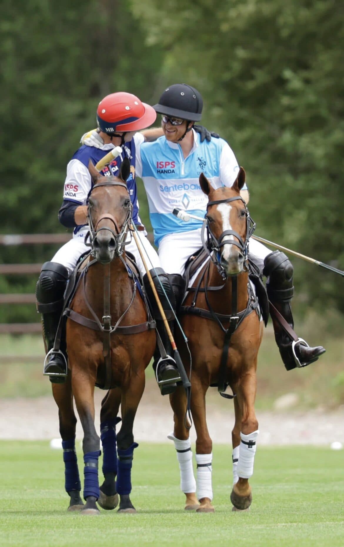 Sentebale polo match, players embracing on horseback